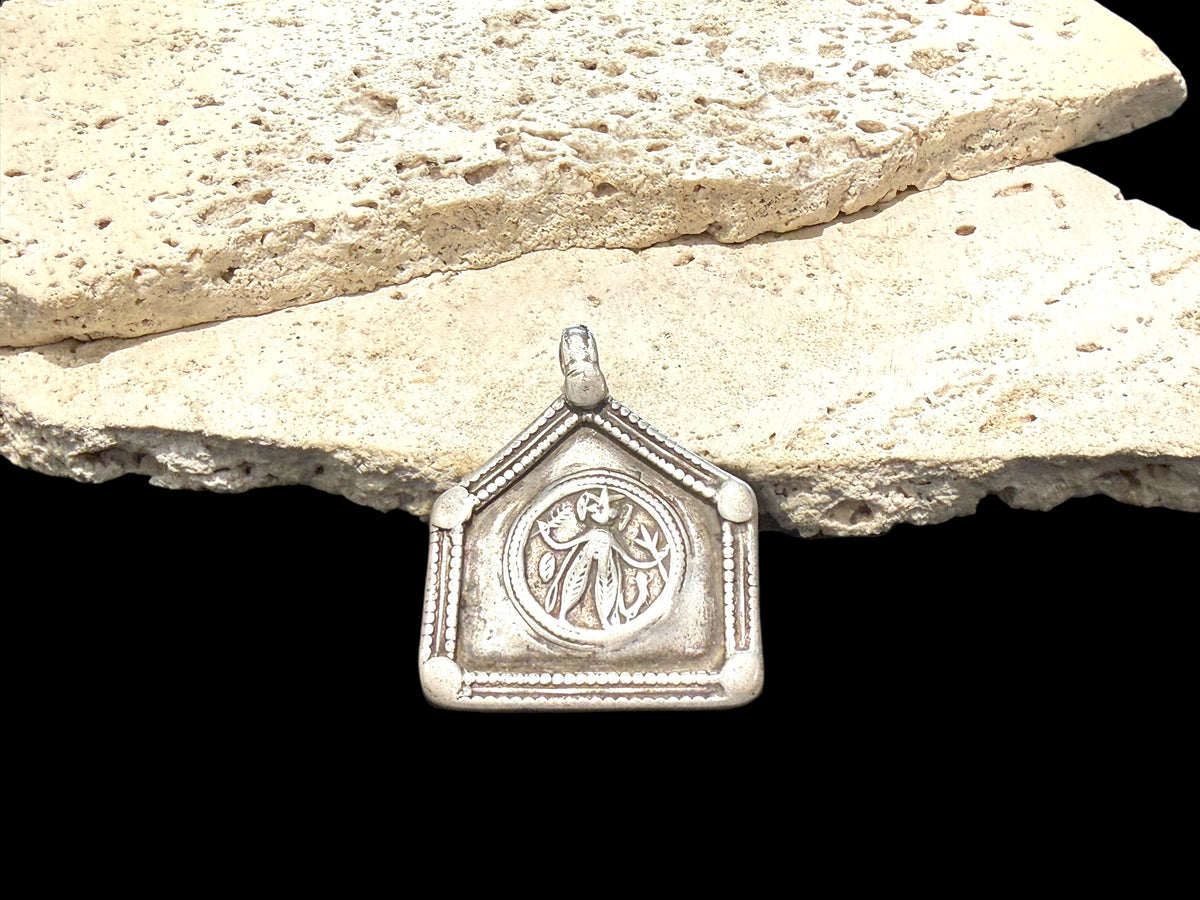 Antique Indian amulet depicting Durga in her Kali Maa form. High grade silver. Early 20th century or earlier. Height 5.3 cm including bail, width 4.5 cm