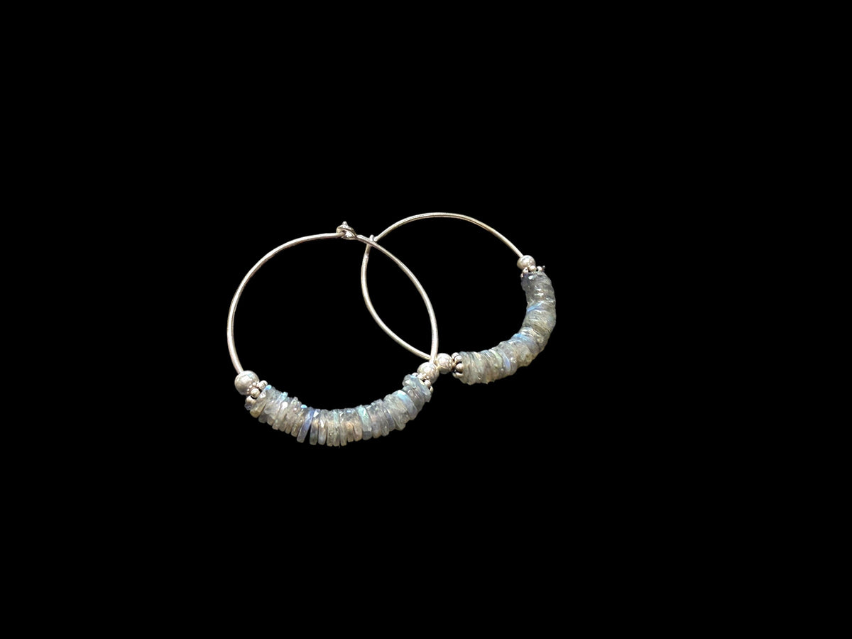 Large labradorite hoop earrings, crafted from flat labradorite stones facet cut on every side to show off their lustre. Sterling silver hoops. 5 cm diameter