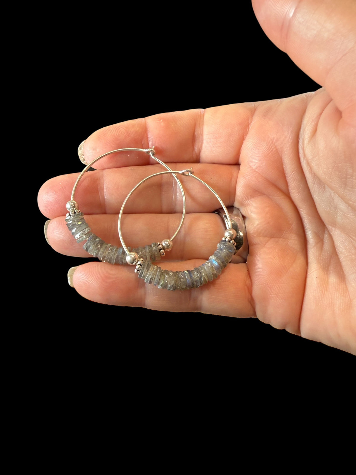 Large labradorite hoop earrings, crafted from flat labradorite stones facet cut on every side to show off their lustre. Sterling silver hoops. 5 cm diameter