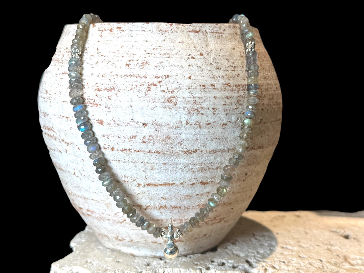 Faceted labradorite rondels, sterling silver detailing and a solid silver pendant, sterling silver hook clasp. Length: 44 cm