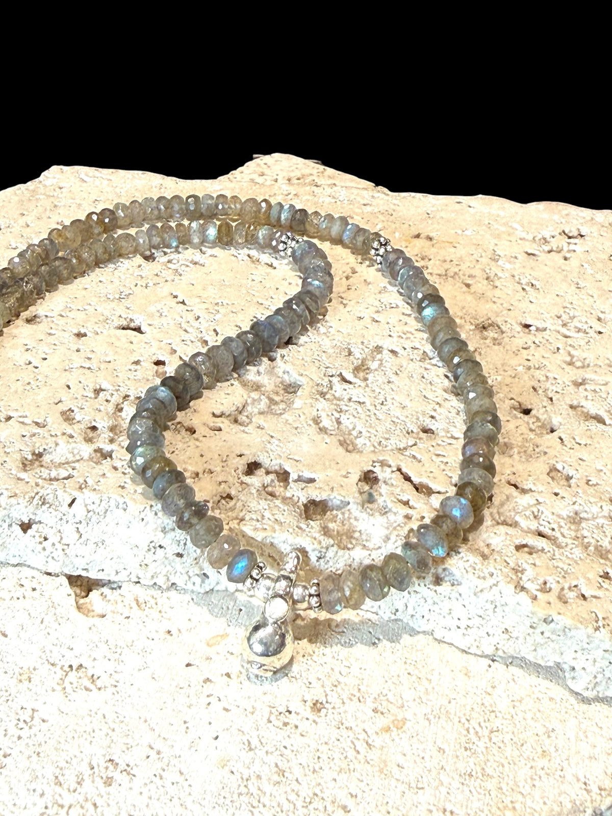 Faceted labradorite rondels, sterling silver detailing and a solid silver pendant, sterling silver hook clasp. Length: 44 cm