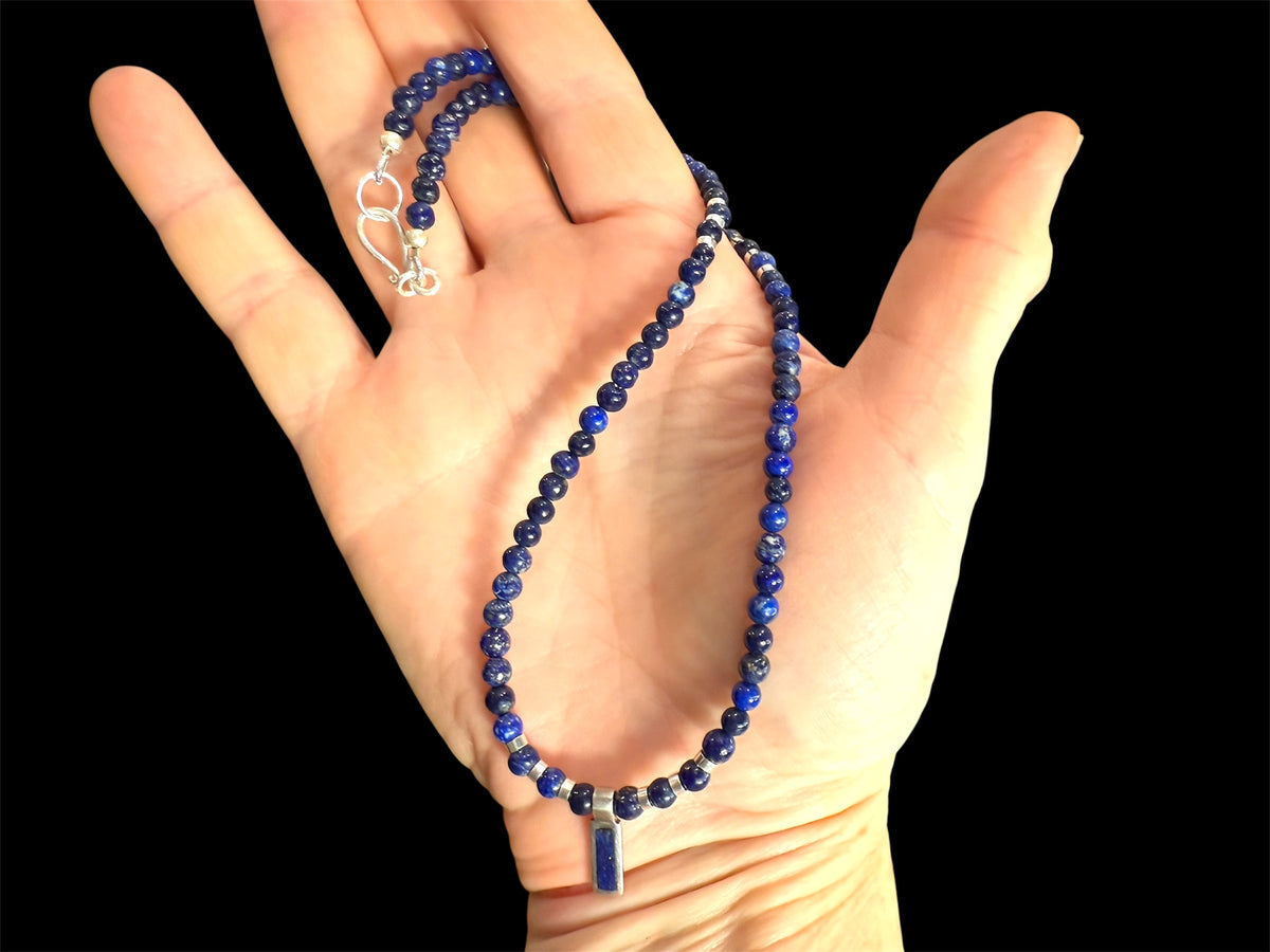 Afghan lapis lazuli with a silver and lapis pendant, highlighted with bright sterling silver beads, finished with a sterling silver hook clasp. Length 41 cm (16.2")