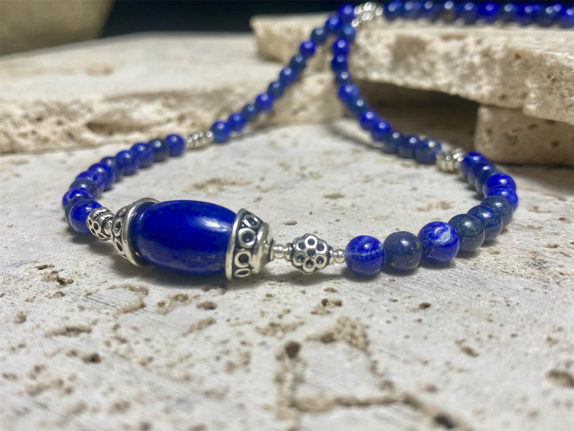 Simple and elegant, our medium length necklace is made from deep blue Afghan lapis lazuli and sterling silver, with a sterling silver clasp. Length 48 cm (19")