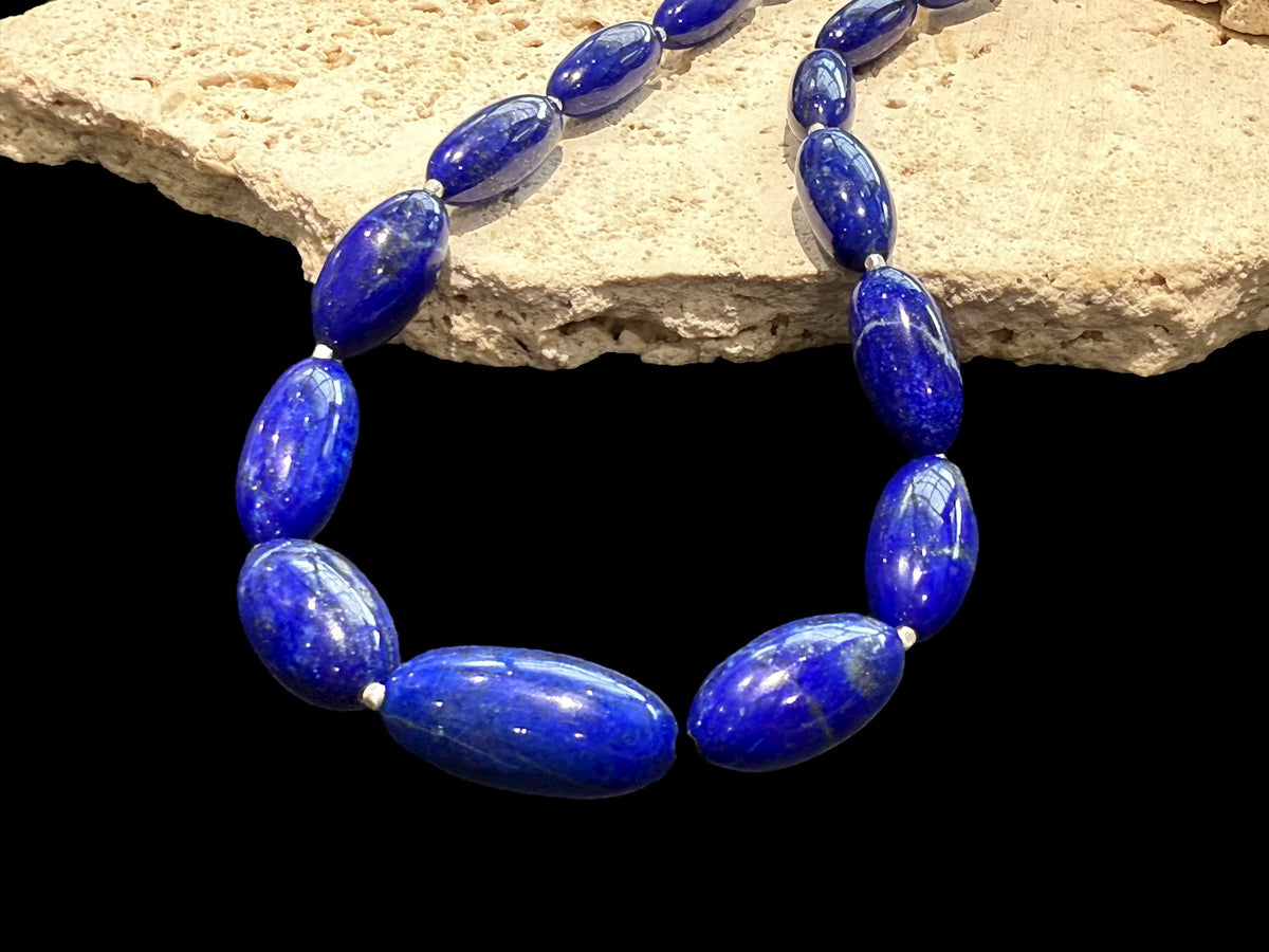 Simple and elegant, this longer length necklace is made from deep blue, AAA grade Afghan lapis lazuli and sterling silver beads, finished with sterling silver findings. Measurements: Length 48 cm (19")