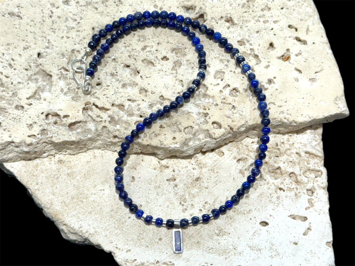 Afghan lapis lazuli with a silver and lapis pendant, highlighted with bright sterling silver beads, finished with a sterling silver hook clasp. Length 41 cm (16.2")