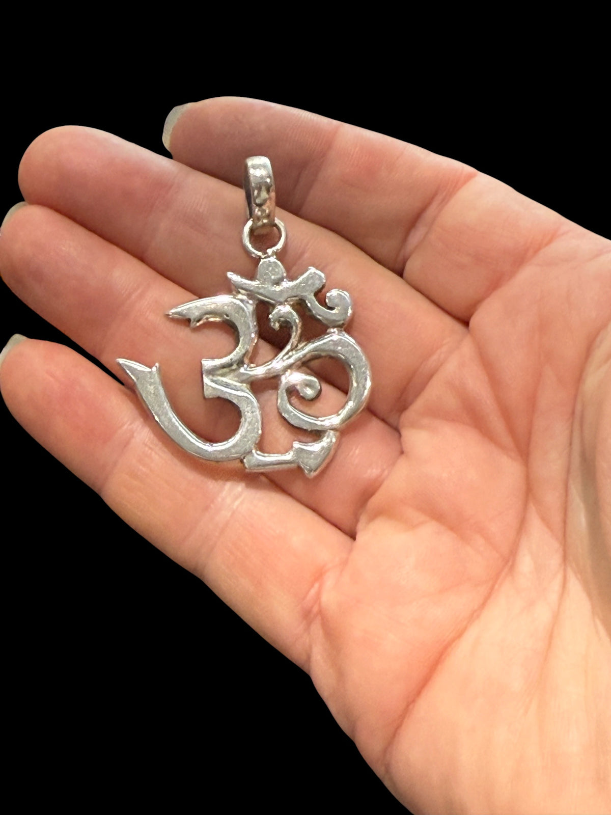 A very large Om pendant, sterling silver. Big bail at top to take the thickest of cords or chains. Height including bail 4.5 cm, width 3.8 cm.