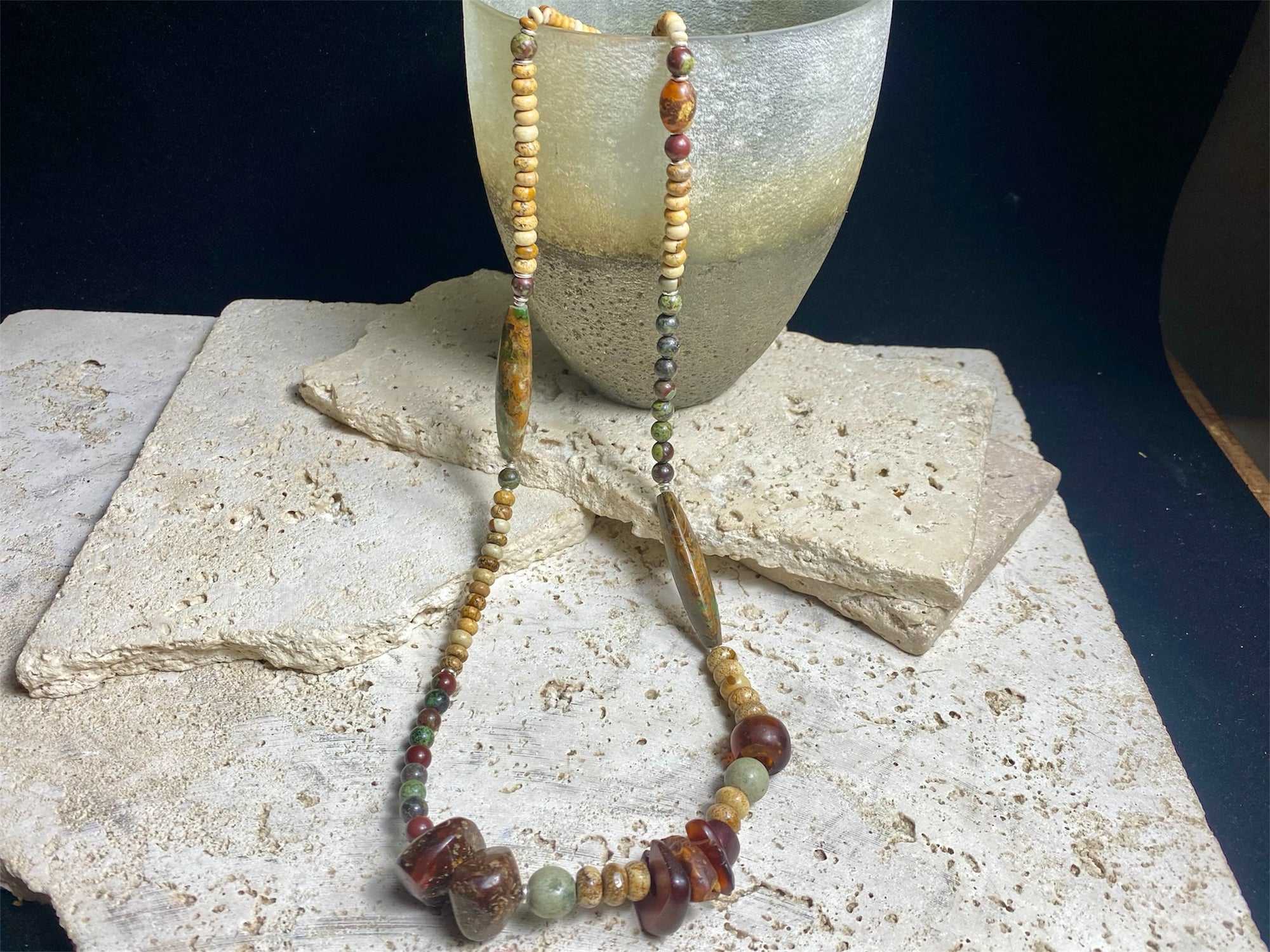 A unique necklace featuring bloodstone,  jasper, Baltic amber and antique amber prayer beads. Highlighted with sterling silver beads and ends. Length 69 cm
