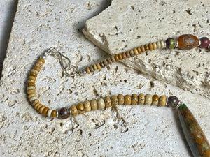 A unique necklace featuring bloodstone,  jasper, Baltic amber and antique amber prayer beads. Highlighted with sterling silver beads and ends. Length 69 cm
