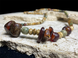 A unique necklace featuring bloodstone,  jasper, Baltic amber and antique amber prayer beads. Highlighted with sterling silver beads and ends. Length 69 cm
