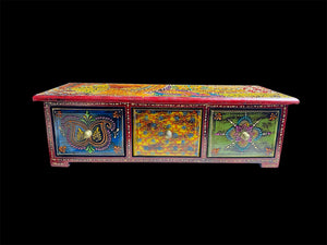 This intricately painted box features three spacious drawers, small feet and brass knobs as handles. The roominess of the drawers means our long, low chest is perfect for holding everything from trinkets to jewellery and essential oils. Width 34.5, depth 13 cm, height 10.5 cm