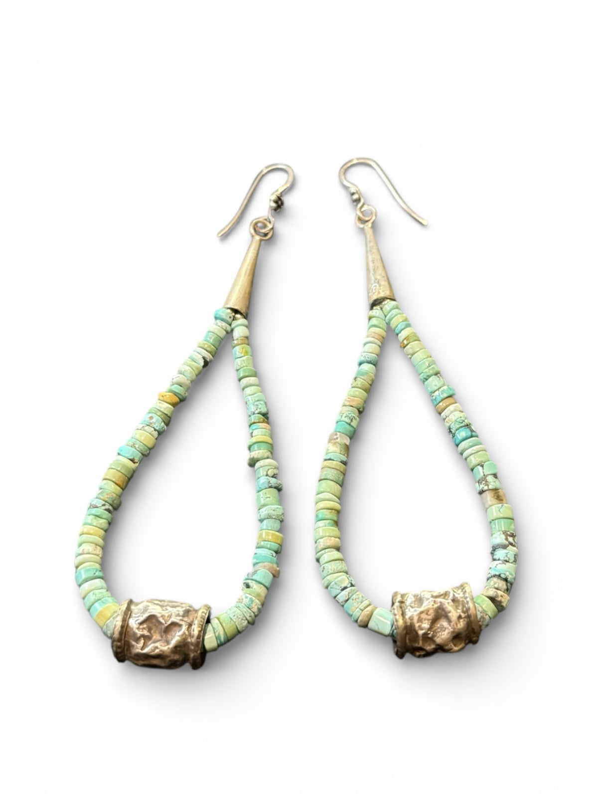 Natural, matte Arizona turquoise is teamed with antique tribal silver beads. The earrings are finished with sterling silver. Measurements: length 10.8 cm