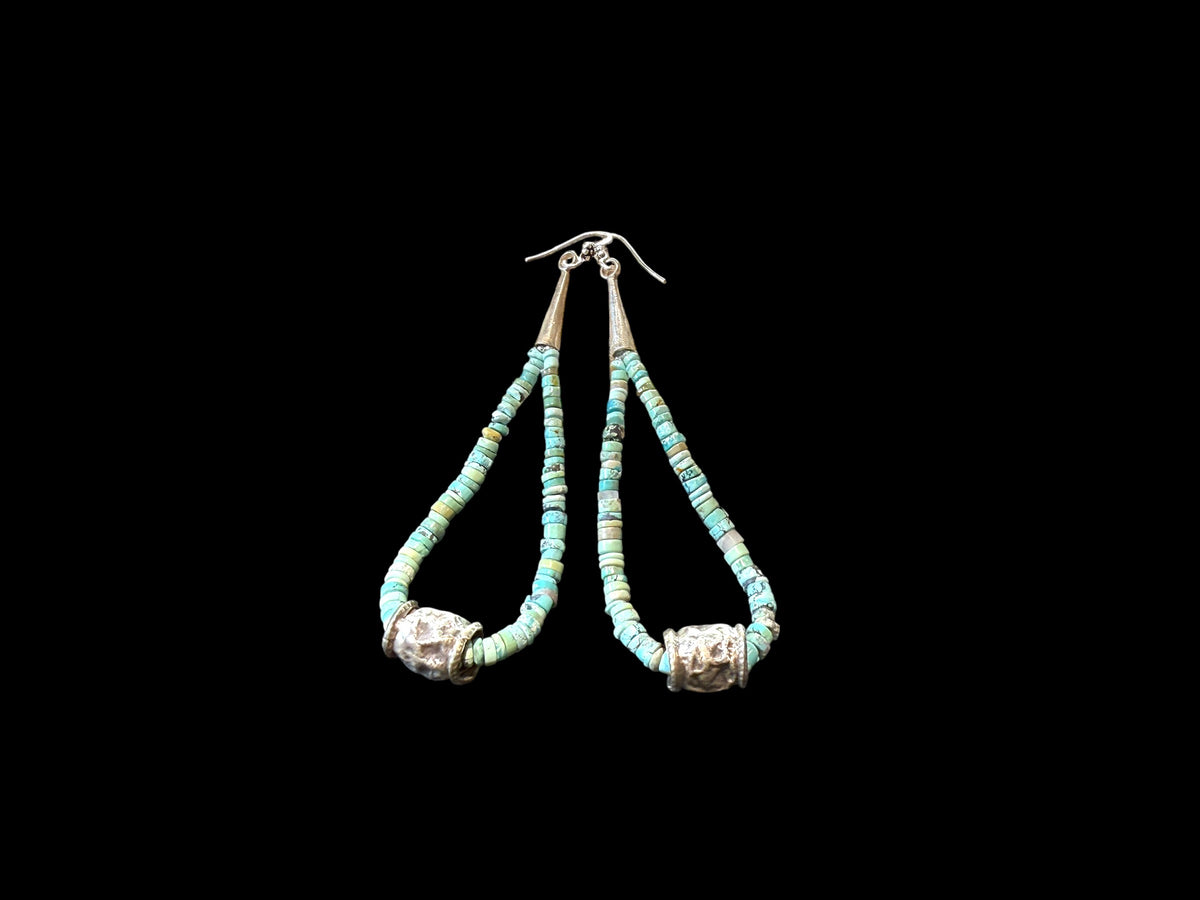 Natural, matte Arizona turquoise is teamed with antique tribal silver beads. The earrings are finished with sterling silver. Measurements: length 10.8 cm