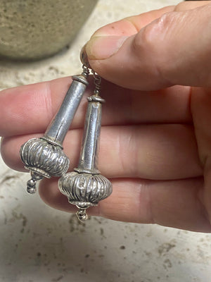 Antique silver beads resembling the mace (Gada) of Hanuman. Balances physical & spiritual energies, worshipped independently for its protective qualities as the goddess Kaumodakī. Sterling silver hooks & components, light to wear. Length 5.7 cm