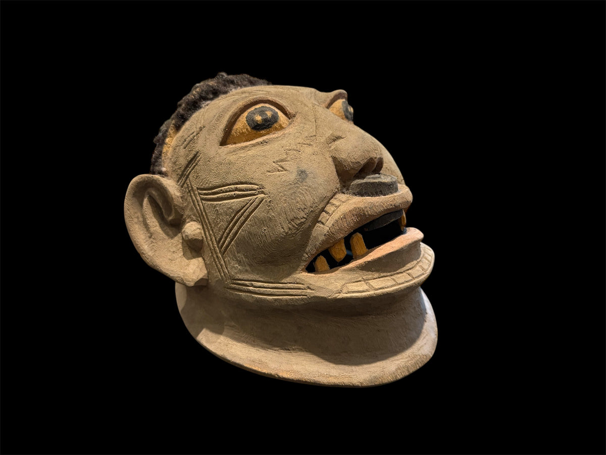 Makonde helmet mask. Balsa wood, human hair and pigment. Moda, Mozambique. Circa mid 90's. Worn in dances that conclude the initiation ceremonies for adolescent boys and girls. Measurements: length 24 cm, width 20 cm, height 22 cm