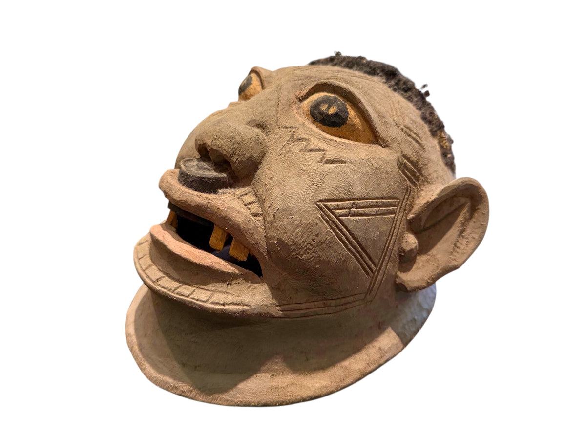 Makonde helmet mask. Balsa wood, human hair and pigment. Moda, Mozambique. Circa mid 90's. Worn in dances that conclude the initiation ceremonies for adolescent boys and girls. Measurements: length 24 cm, width 20 cm, height 22 cm