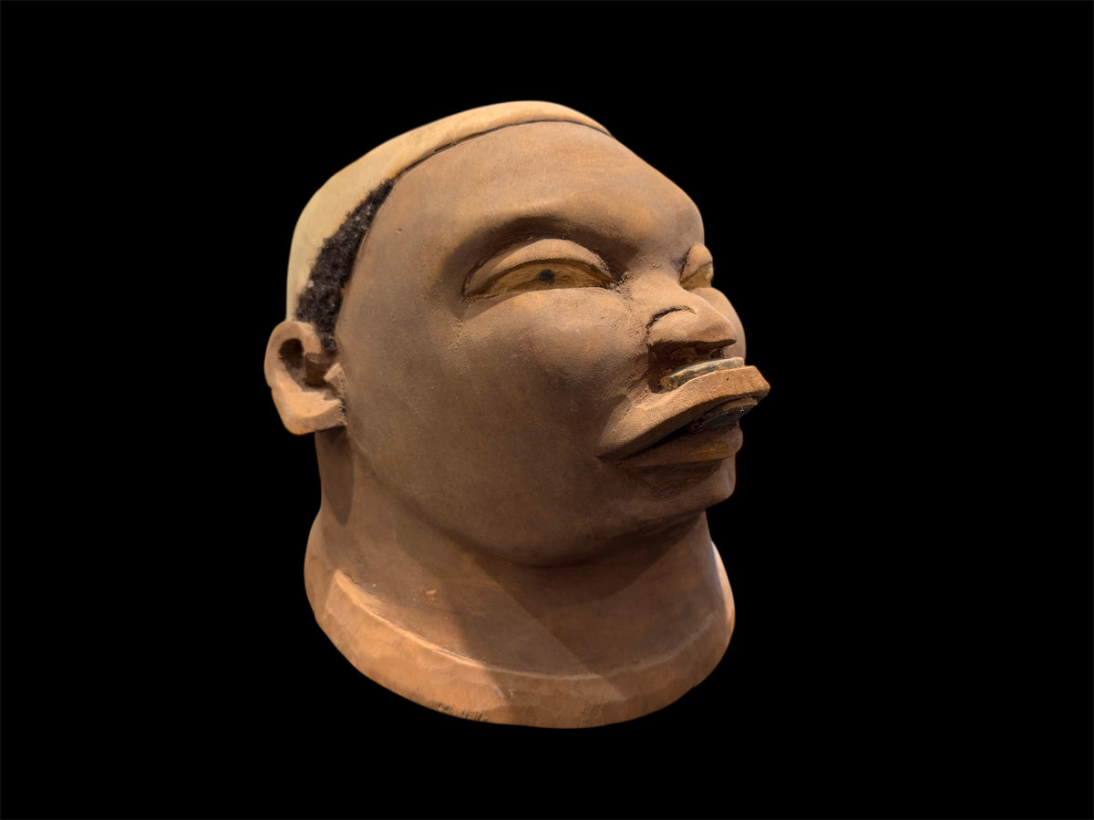 Makonde helmet mask. Balsa wood, human hair and pigment. Moda, Mozambique, Circa mid 90's. Worn in dances that conclude the initiation ceremonies for adolescent boys and girls. Measurements: length 25 cm, width 19 cm, height 20 cm