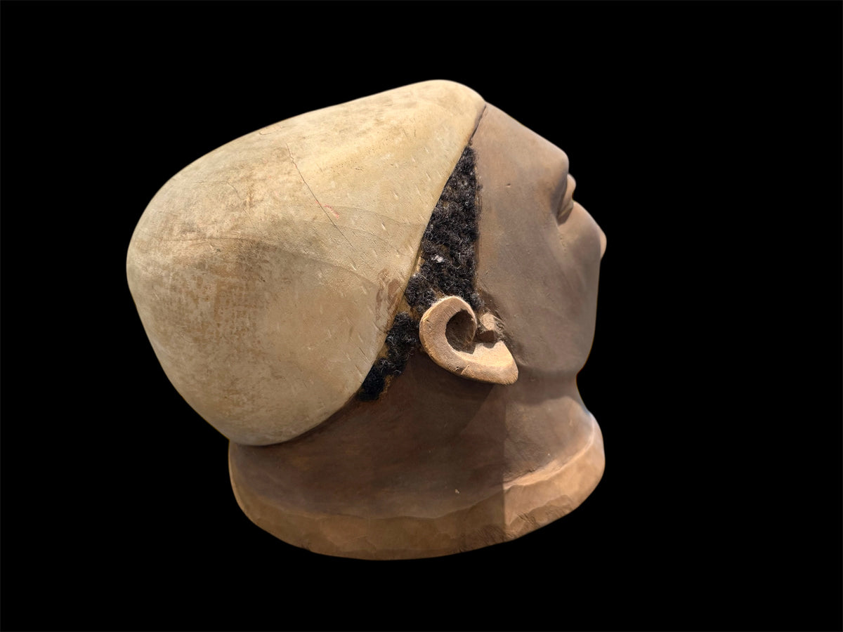 Makonde helmet mask. Balsa wood, human hair and pigment. Moda, Mozambique, Circa mid 90's. Worn in dances that conclude the initiation ceremonies for adolescent boys and girls. Measurements: length 25 cm, width 19 cm, height 20 cm