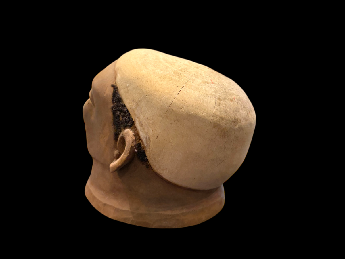 Makonde helmet mask. Balsa wood, human hair and pigment. Moda, Mozambique, Circa mid 90's. Worn in dances that conclude the initiation ceremonies for adolescent boys and girls. Measurements: length 25 cm, width 19 cm, height 20 cm