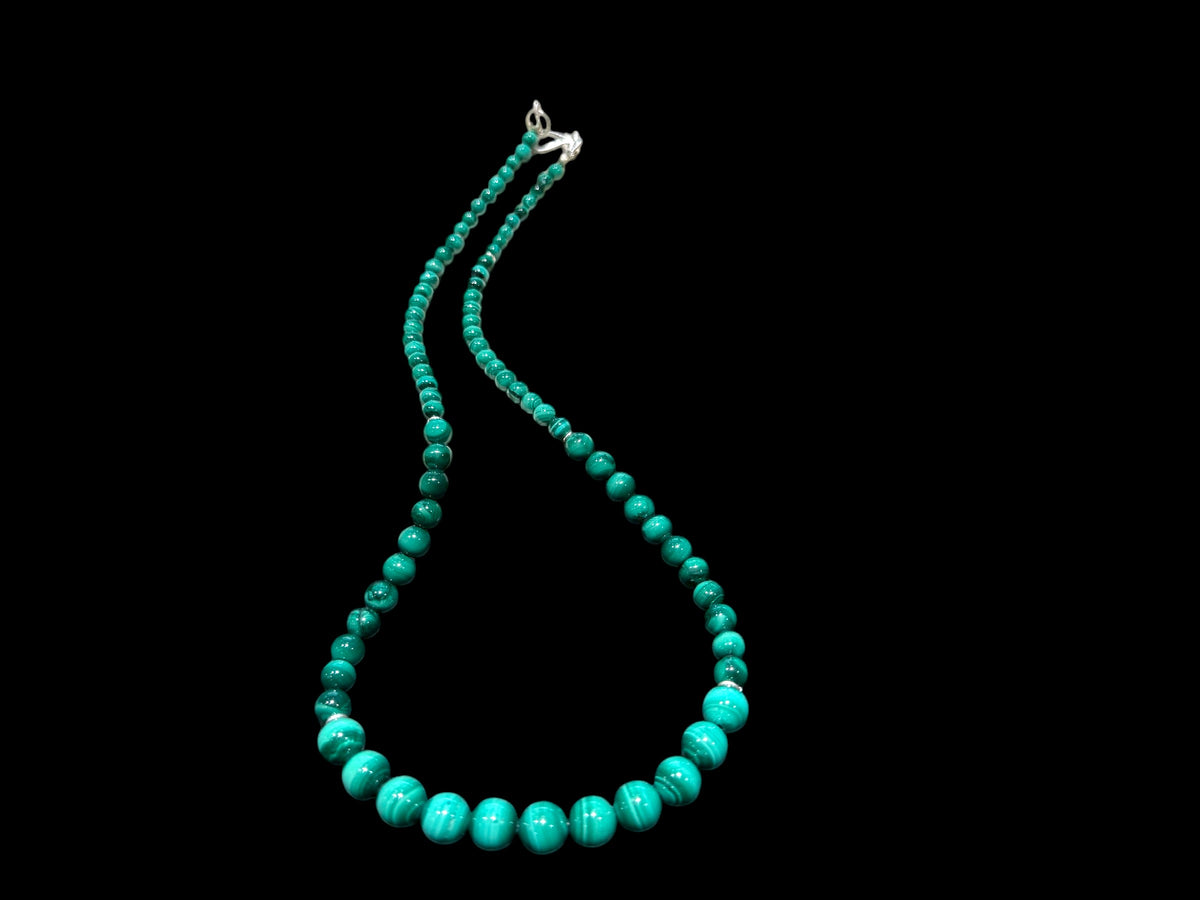 Graduated round malachite beads are highlighted with the smallest amount of sterling silver detailing and a sturdy hook clasp. Measurements: 47.2 cm length. Bead diameter 8mm, 6mm, 4mm and 3mm