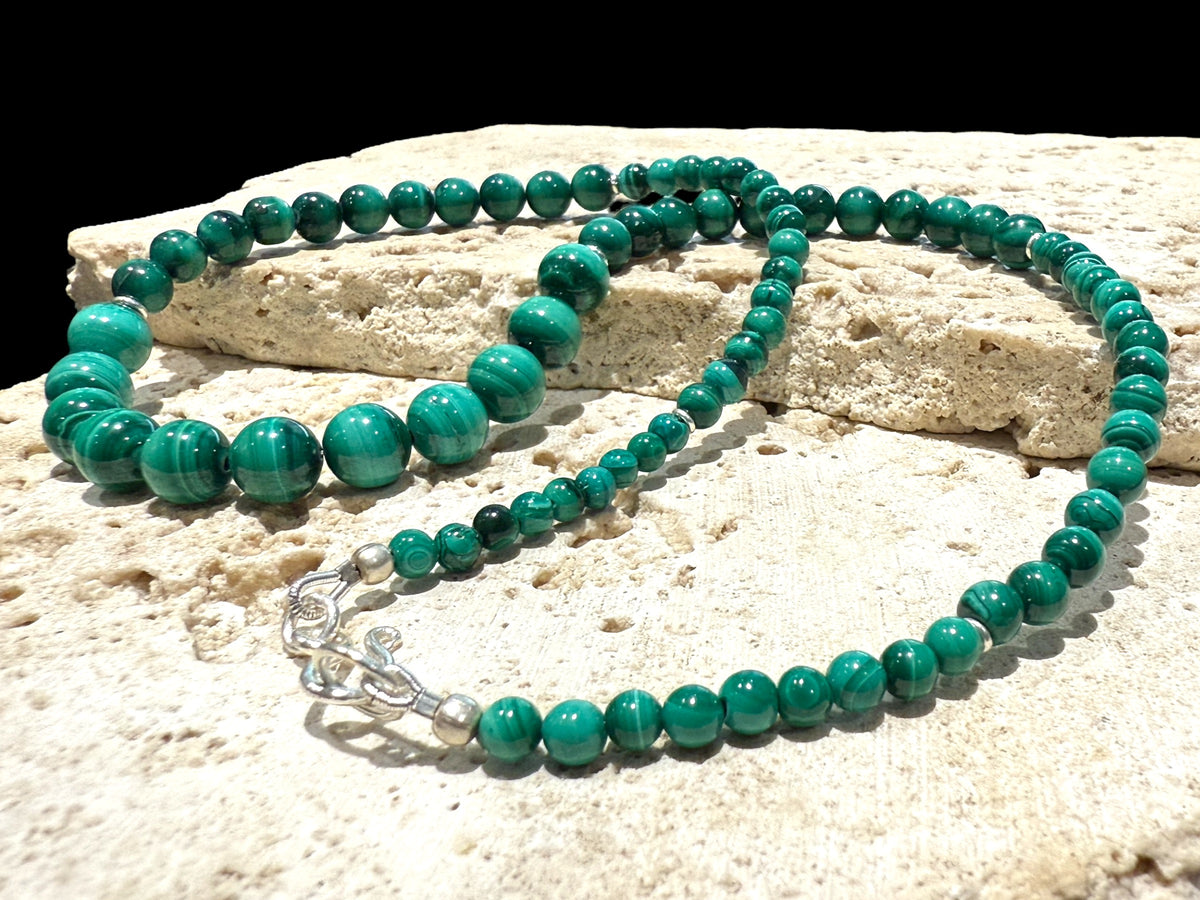 Graduated round malachite beads are highlighted with the smallest amount of sterling silver detailing and a sturdy hook clasp. Measurements: 47.2 cm length. Bead diameter 8mm, 6mm, 4mm and 3mm