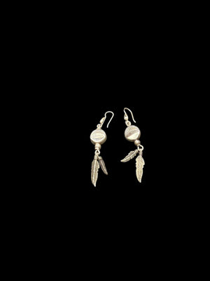 These medicine drum earrings have two feathers dangling below. The beads are vintage and all components including the hooks are sterling silver.&nbsp;

Measurements: length 6 cm