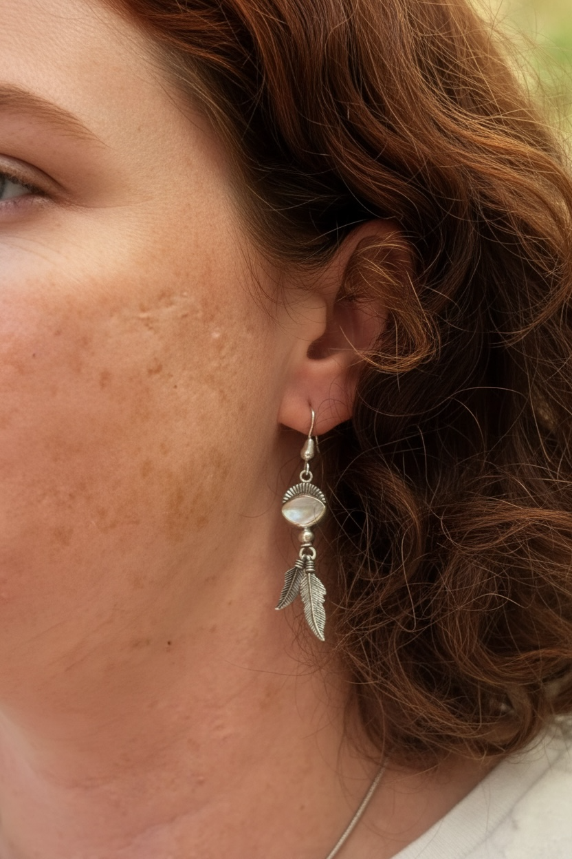 These medicine drum earrings have two feathers dangling below. The beads are vintage and all components including the hooks are sterling silver.&nbsp;

Measurements: length 6 cm
