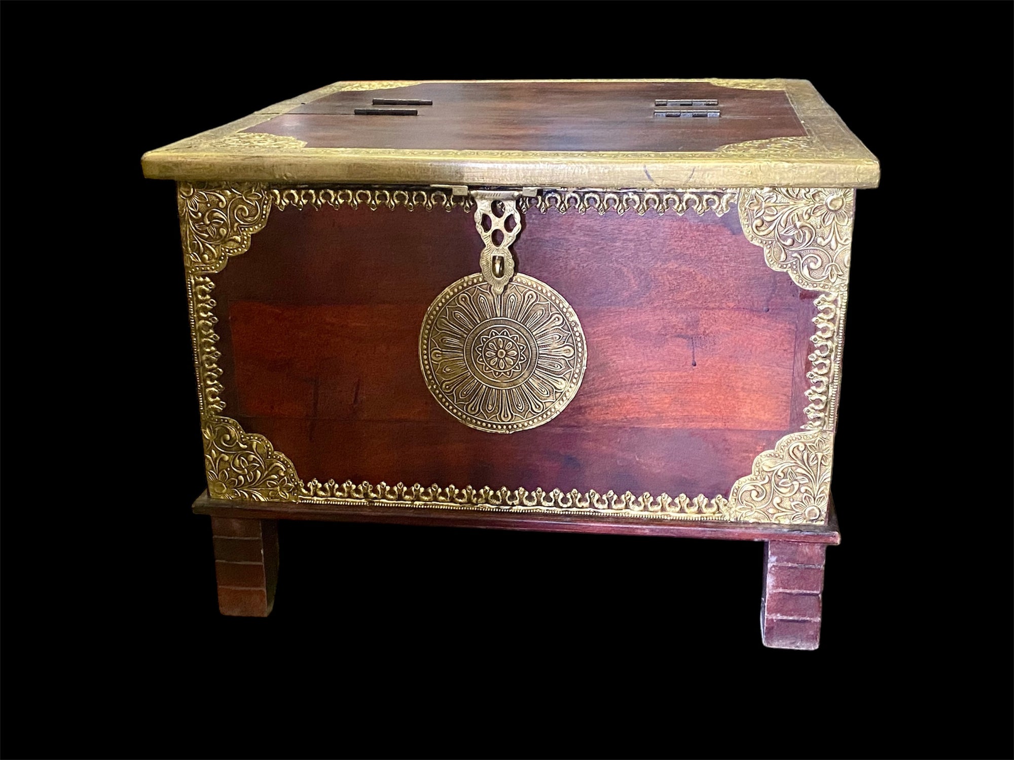 Hardwood coffee table chest with dual opening lid and brass decoration. This lovely and practical chest can be used as a side table, small coffee table or storage chest. It is stained brown-red and is finished with brass decoration. Both sides open. From Rajasthan, India. Measurements: 61 x 61 cm, height 46 cm.