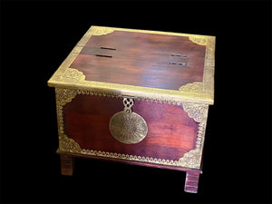 Hardwood coffee table chest with dual opening lid and brass decoration. This lovely and practical chest can be used as a side table, small coffee table or storage chest. It is stained brown-red and is finished with brass decoration. Both sides open. From Rajasthan, India. Measurements: 61 x 61 cm, height 46 cm.