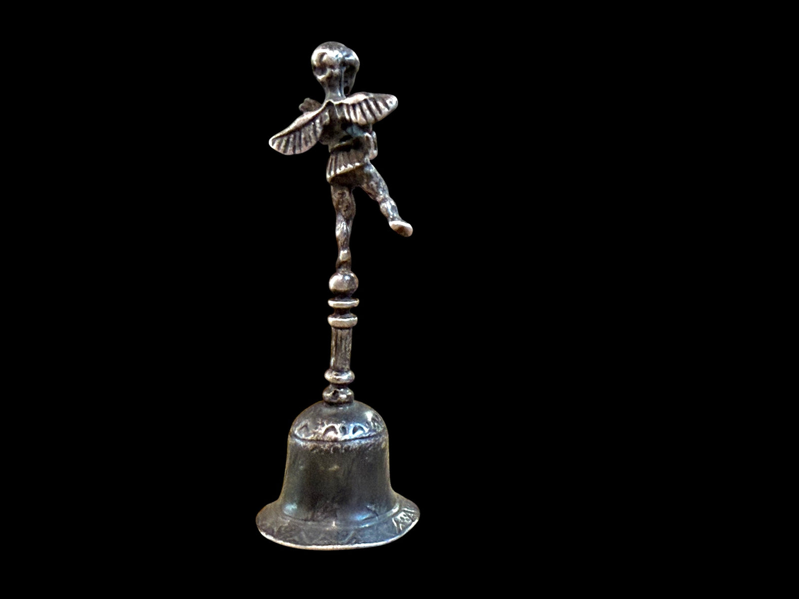 Small, decorative vintage bell with winged putto and dolphin. Sweet tone. Marked 800 ie 80% silver. From Italy. Height 6.4 cm. Diameter of bell's base 2.2 cm.