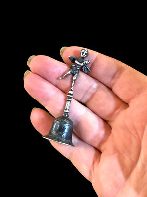 Small, decorative vintage bell with winged putto and dolphin. Sweet tone. Marked 800 ie 80% silver. From Italy. Height 6.4 cm. Diameter of bell's base 2.2 cm.