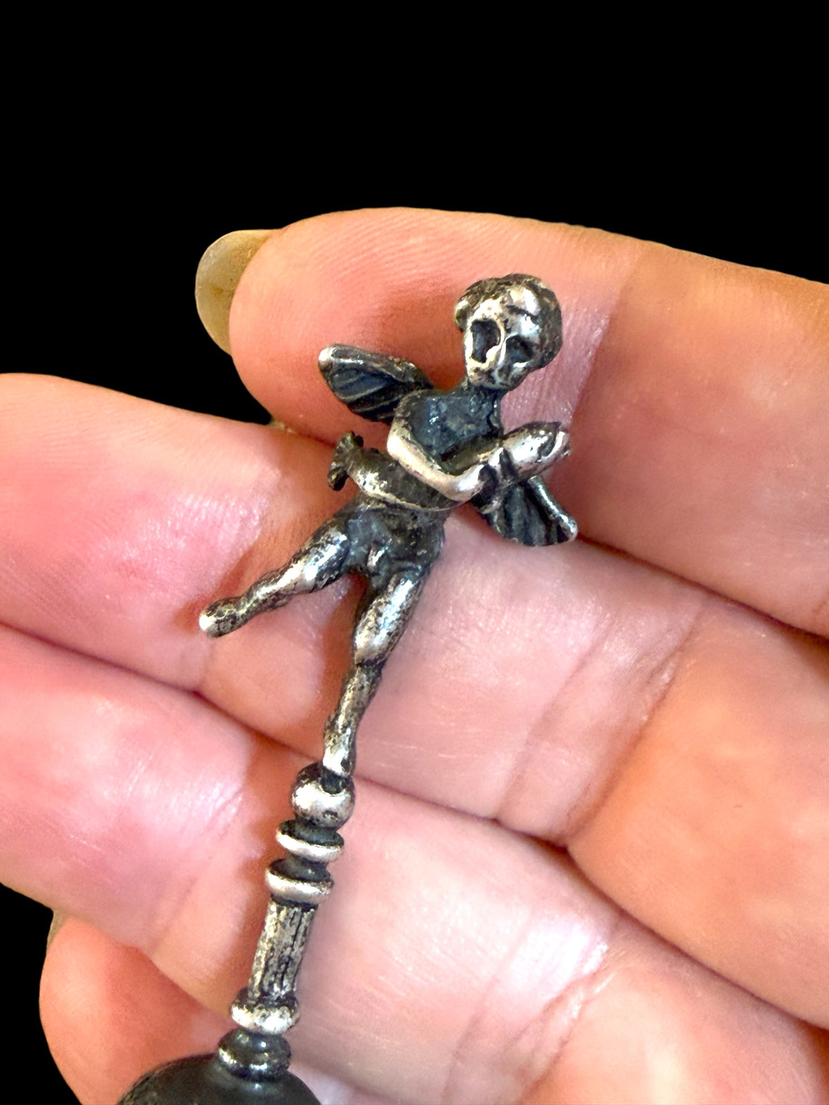 Small, decorative vintage bell with winged putto and dolphin. Sweet tone. Marked 800 ie 80% silver. From Italy. Height 6.4 cm. Diameter of bell's base 2.2 cm.