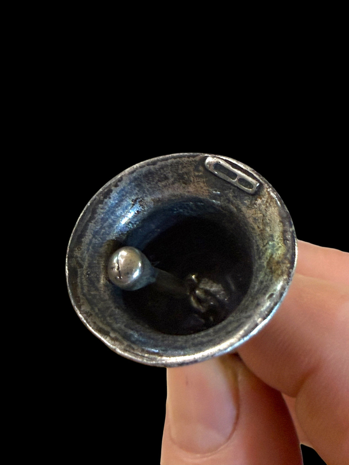 Small, decorative vintage bell with winged putto and dolphin. Sweet tone. Marked 800 ie 80% silver. From Italy. Height 6.4 cm. Diameter of bell's base 2.2 cm.