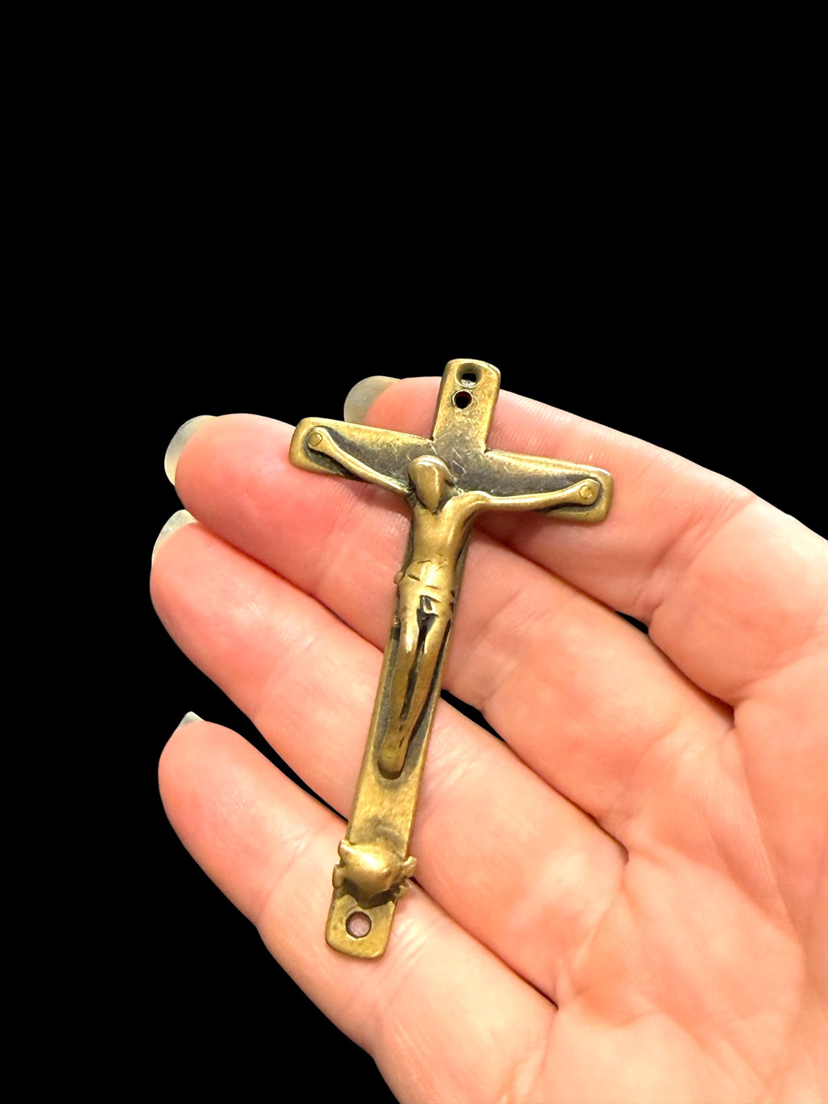 Late 19th C Italian crucifix. Brass, rubbed. Naples, Italy. Christ on cross with skull and crossbones below, representing Adam’s skull. H 6.6 cm, W 3.7 cm
