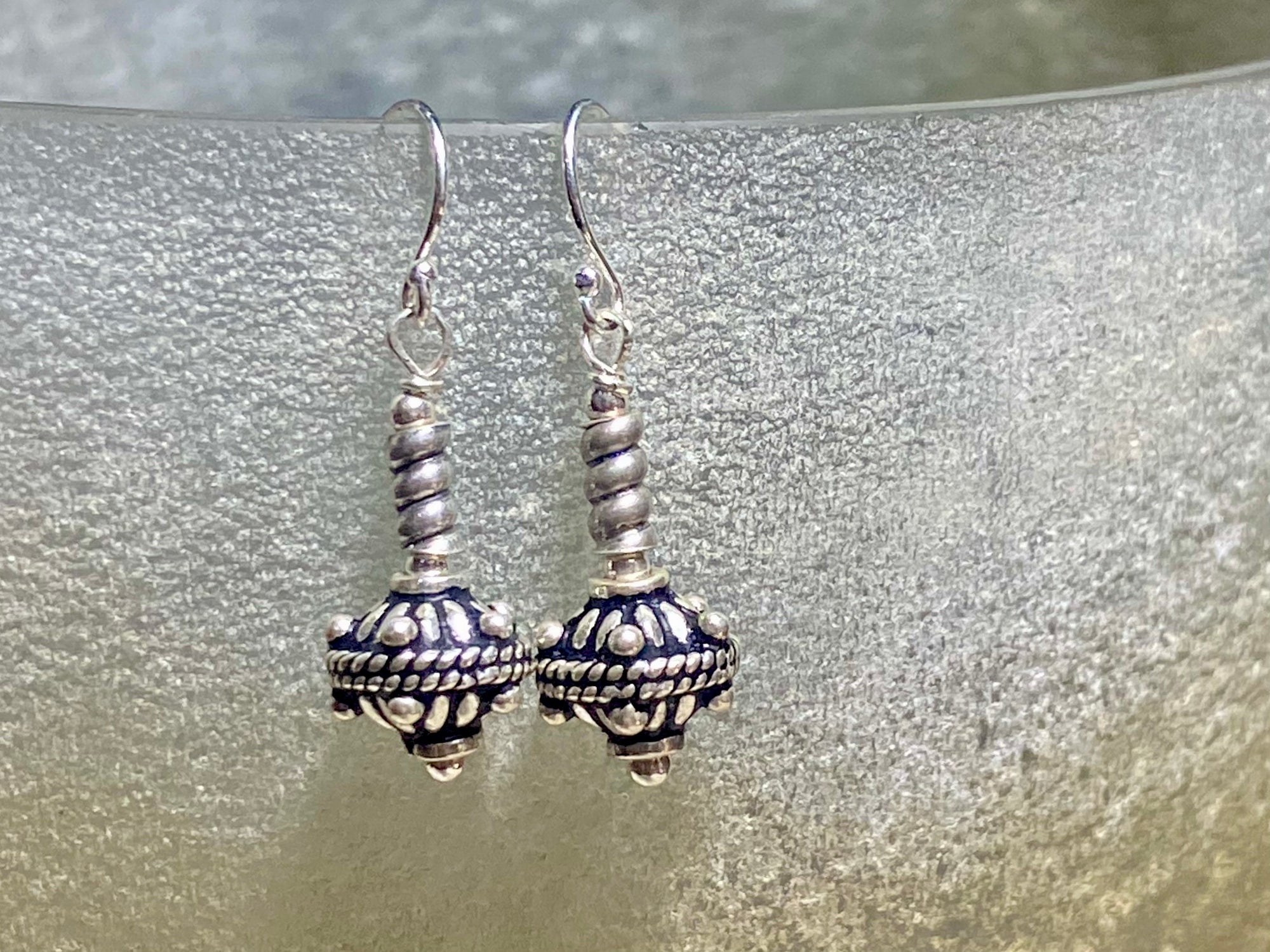 Sterling silver earrings featuring intricate, handmade tribal beads and silver hooks. Light and easy to wear, but these little earrings will make an impact. Length 3 cm including hook