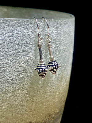 Sterling silver earrings featuring intricate, handmade tribal beads and silver hooks. Light and easy to wear, but these little earrings will make an impact. Length 2.8 cm including hook