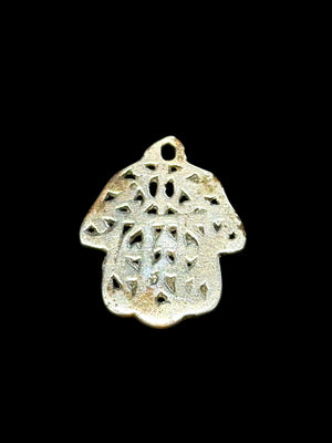 Antique Tunisian silver hamsa amulet pendant. Cast openwork decoration, rounded outline, softened detail consistent with wear. Height 3.5 cm, width 2.6 cm