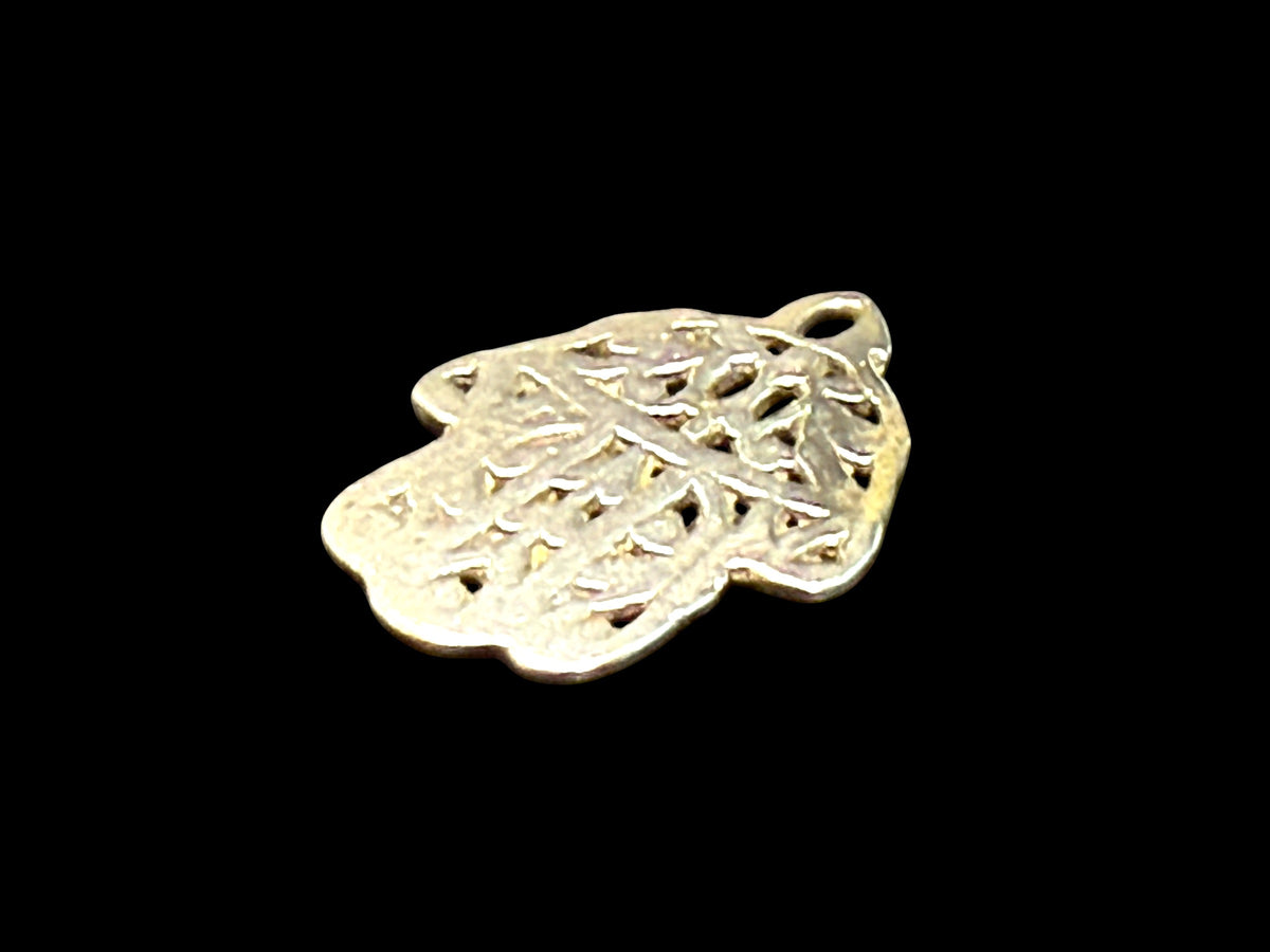 Antique Tunisian silver hamsa amulet pendant. Cast openwork decoration, rounded outline, softened detail consistent with wear. Height 3.5 cm, width 2.6 cm