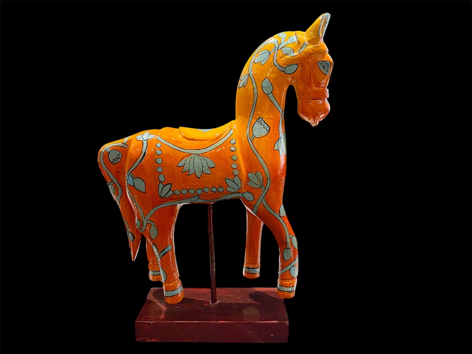 Bright and beautiful, our large horse statue is carved from solid hard wood and painted in burn orange with blue detail. A modern piece for all horse lovers, hand made in Rajasthan, India.

Measurements: height to ear 33 cm, length 24 cm, width 8 cm.