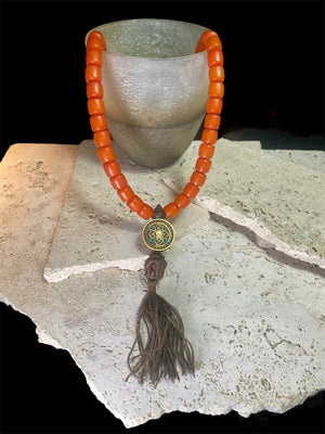 Mala of 54 beads. Resin beads highlighted with a brass pendant featuring the viswa vajra & Om mantra & Buddha bead in Vietnamese sandalwood, 62 cm total length.