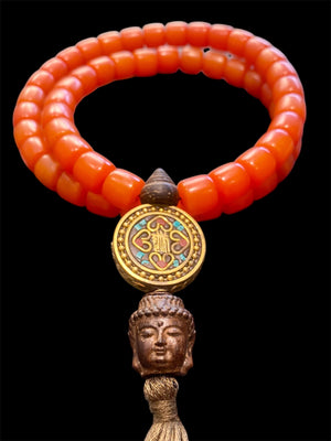 Mala of 54 beads. Resin beads highlighted with a brass pendant featuring the viswa vajra & Om mantra & Buddha bead in Vietnamese sandalwood, 62 cm total length.