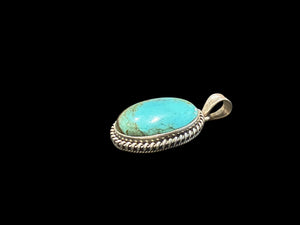 Large oval turquoise pendant is set off by a twist-rope sterling silver bezel, Measurements: 4 cm height including bail