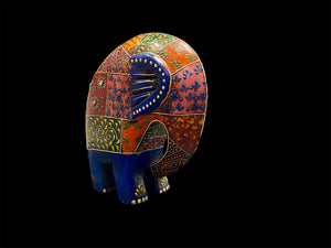 Our cutest elephant statue. Hand carved from solid hard wood, these elephants are full of character, are crafted in Rajasthan, India, and painted in intricate embossed detail. measurements: height 1 cm, length 15 cm, depth 6 cm