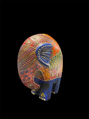 Our cutest elephant statue. Hand carved from solid hard wood, these elephants are full of character, are crafted in Rajasthan, India, and painted in intricate embossed detail. measurements: height 1 cm, length 15 cm, depth 6 cm