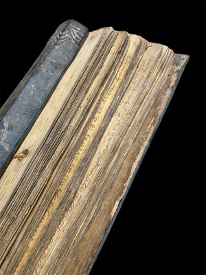 Sinhalese palm (ola) leaf book, ca. early 20th century CE. South Asia. Religious text from a Hindu-Buddhist monastery. Contains 60 leaves bound by two cords between a pair of wood slat covers. Measurements: Length 56 cm (22") x height 7.5 cm (3") x width 4.5 cm (1.75")