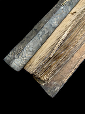 Sinhalese palm (ola) leaf book, ca. early 20th century CE. South Asia. Religious text from a Hindu-Buddhist monastery. Contains 60 leaves bound by two cords between a pair of wood slat covers. Measurements: Length 56 cm (22") x height 7.5 cm (3") x width 4.5 cm (1.75")