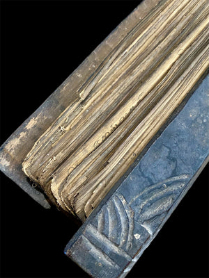 Sinhalese palm (ola) leaf book, ca. early 20th century CE. South Asia. Religious text from a Hindu-Buddhist monastery. Contains 60 leaves bound by two cords between a pair of wood slat covers. Measurements: Length 56 cm (22") x height 7.5 cm (3") x width 4.5 cm (1.75")