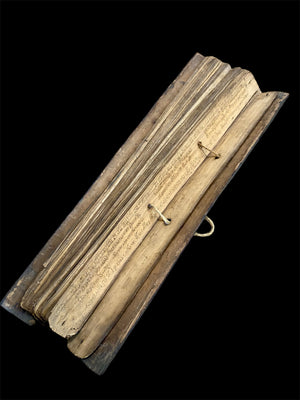 Sinhalese palm (ola) leaf book, ca. early 20th century CE. South Asia. Religious text from a Hindu-Buddhist monastery. Contains 60 leaves bound by two cords between a pair of wood slat covers. Measurements: Length 56 cm (22") x height 7.5 cm (3") x width 4.5 cm (1.75")