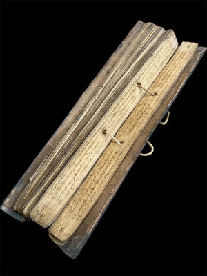 Sinhalese palm (ola) leaf book, ca. early 20th century CE. South Asia. Religious text from a Hindu-Buddhist monastery. Contains 60 leaves bound by two cords between a pair of wood slat covers. Measurements: Length 56 cm (22") x height 7.5 cm (3") x width 4.5 cm (1.75")