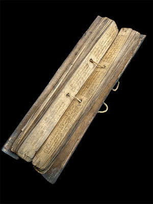 Sinhalese palm (ola) leaf book, ca. early 20th century CE. South Asia. Religious text from a Hindu-Buddhist monastery. Contains 60 leaves bound by two cords between a pair of wood slat covers. Measurements: Length 56 cm (22") x height 7.5 cm (3") x width 4.5 cm (1.75")