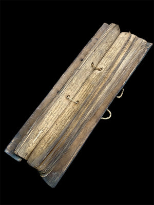 Sinhalese palm (ola) leaf book, ca. early 20th century CE. South Asia. Religious text from a Hindu-Buddhist monastery. Contains 60 leaves bound by two cords between a pair of wood slat covers. Measurements: Length 56 cm (22") x height 7.5 cm (3") x width 4.5 cm (1.75")